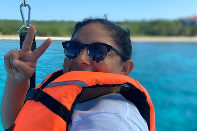 Best Parasailing Cozumel + Locker - After landing: seats, harness removal, and beach-club downtime