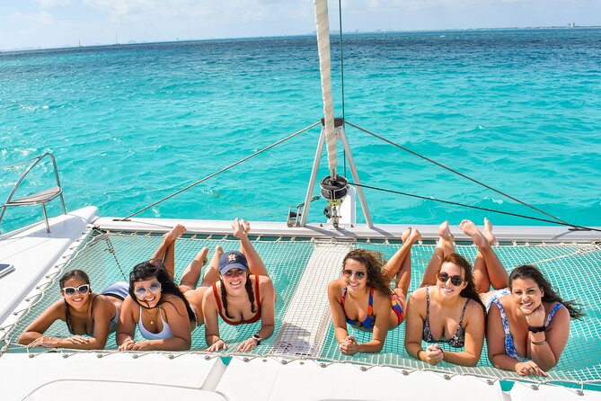Isla Mujeres Catamaran Tour with Snorkel, Open bar and Transport - Onboard open bar, music, and the party vibe