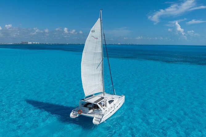 Isla Mujeres Day Tour with Catamaran, Snorkeling & Beach Club - Catamaran Cruise to Bahia Mujeres, Open Bar, and Group Flow